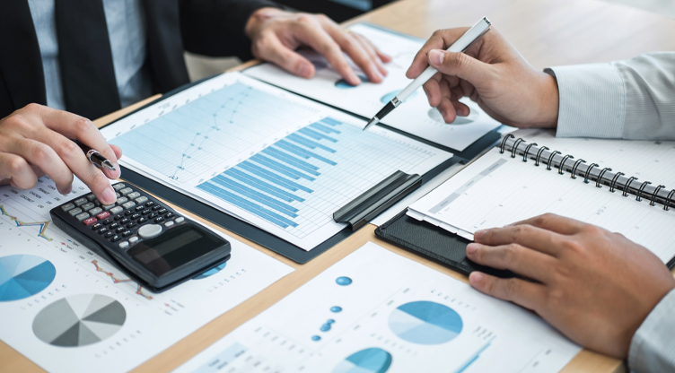 Business people writing on investment graphs