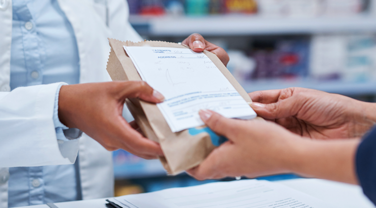doctor handing over meds to person over the counter