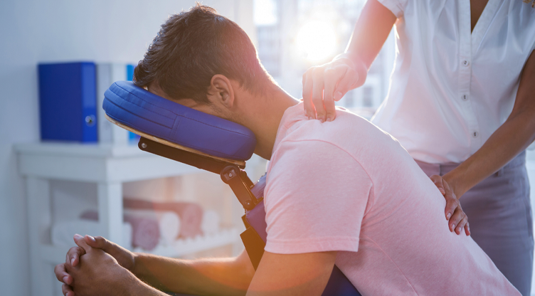 man getting massage in massage chair