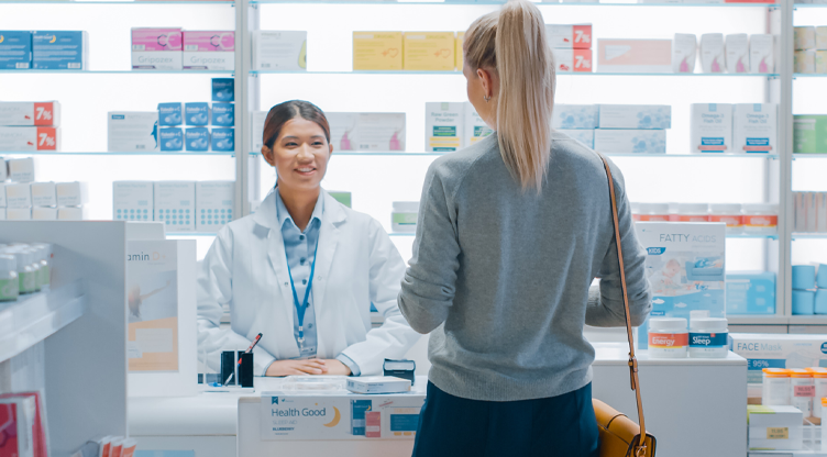 woman buying meds at the pharmacy