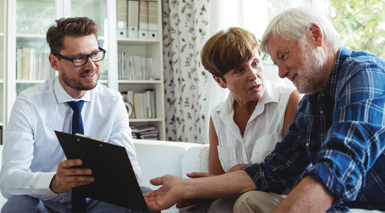 Old couple getting advice from advisor on couch