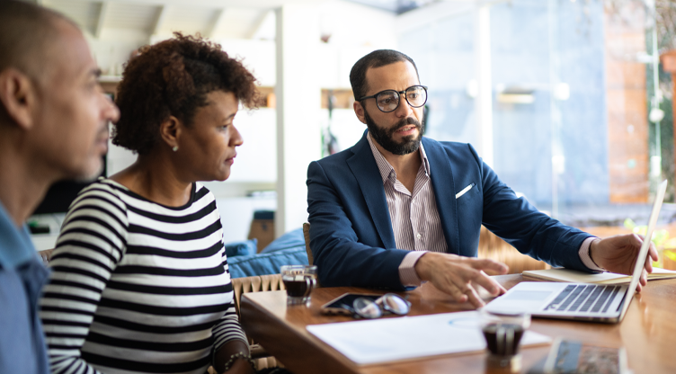 advisor showing clients something on computer