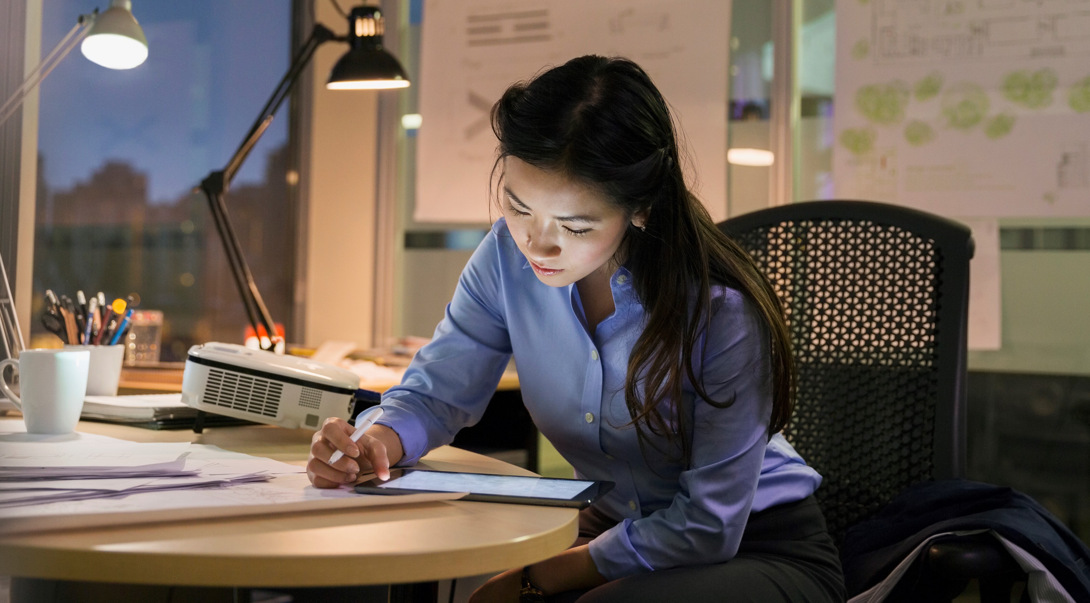 Woman on ipad working at night