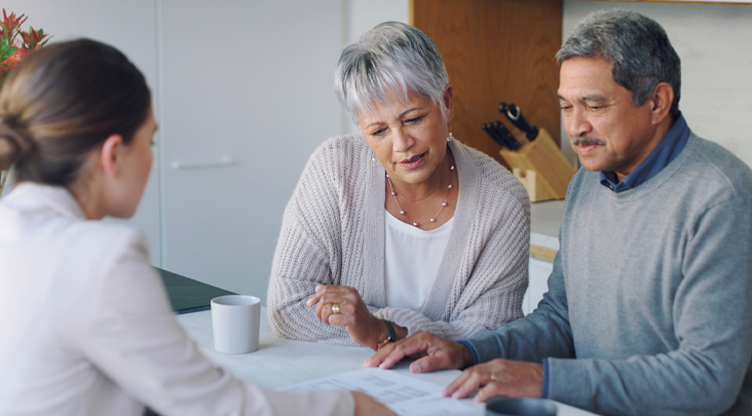 female advisor sharing documents with retired couple
