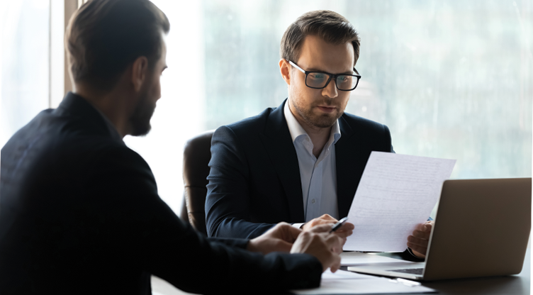 man looking at letters at desk