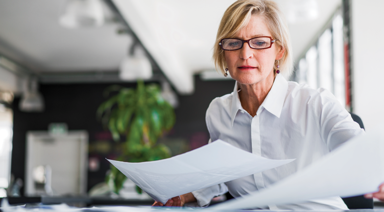 older woman looking through papers