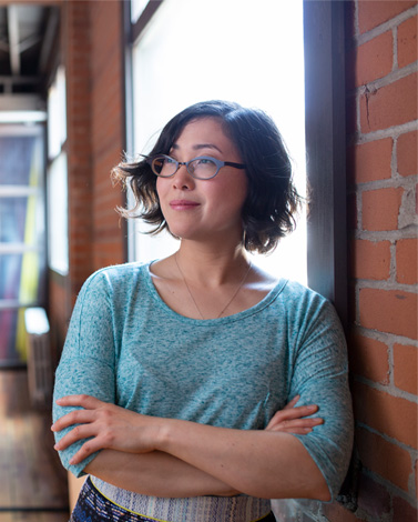 person-thinking-in-front-of-brick-wall