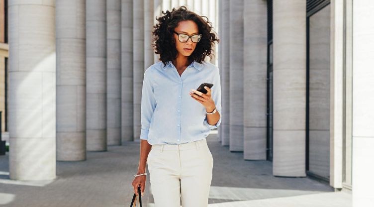 woman on the streets looking at her phone