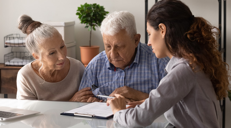 young advisor meeting with older couple about security